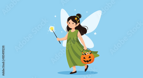 Cute little girl in a green fairy costume with wings holds a magic wand and a pumpkin candy basket for Halloween trick or treating.
