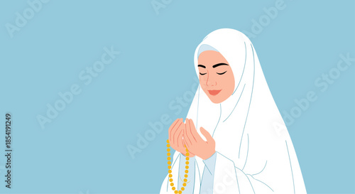 Beautiful young woman in a white prayer veil is seen in a state of deep devotion with her hands raised in prayer on a blue background.