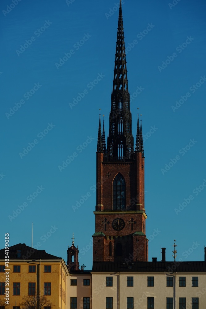 Fototapeta premium Riddarholmen Church Spire Against Clear Blue Sky in Stockholm