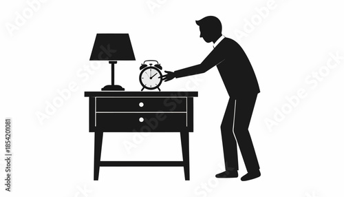 Silhouette of a man turning off an alarm clock on a nightstand with a lamp.