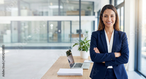 Beautiful hispanic senior business woman with crossed arms smiling at camera. European or latin confident mature middle age leader female businesswoman standing at office workplace, copy space. 