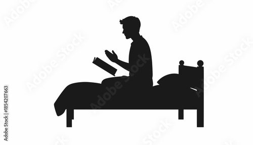 Silhouette of a man reading a book in bed before sleep.