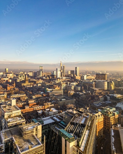 Vertical aerial view over the city centre of Leeds, showing dense urban architecture, streets, and modern cityscape from above.