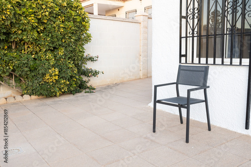 Empty chair waiting on a quiet outdoor patio