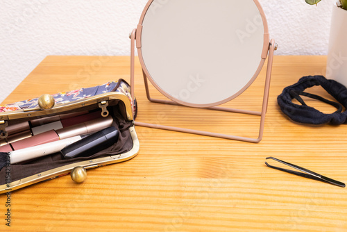 Essential makeup tools laying on a wooden table