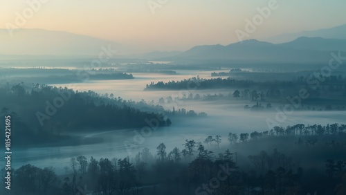 A serene landscape of rolling hills and misty valleys at dawn