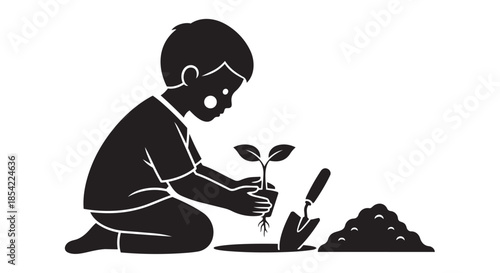 A young boy carefully plants a small seedling, engaging in the joy of gardening and nature
