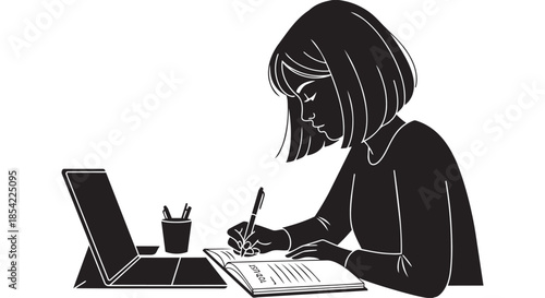 Focused young woman writing in a notebook at a desk with a laptop and pen holder