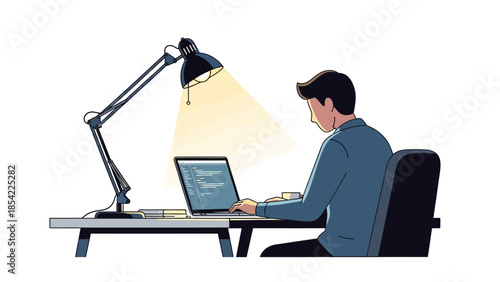 Concentrated professional working diligently on a laptop at a desk with an illuminated lamp, showcasing focused productivity and dedicated effort