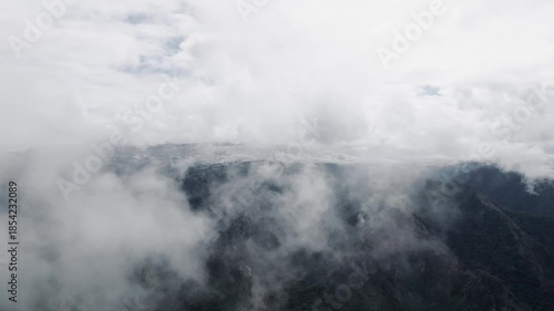 Aerial view of movement through clouds or very close to clouds in mountainous areas