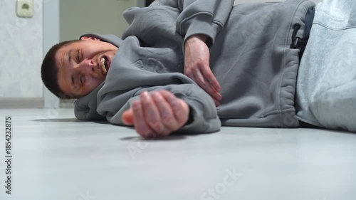 A man fell to the floor after a sudden heart attack.
Health problems for the man lying on the floor.
Falling to the floor and hitting his head.
A man recovering from a heart attack.
Fall, floor, man, 