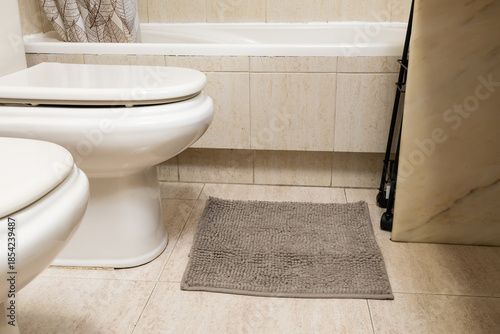 Toilet and bidet in modern clean bathroom interior