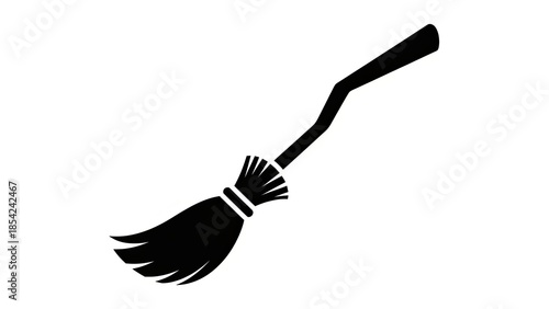 Black silhouette of a witch's broomstick flying against a white background