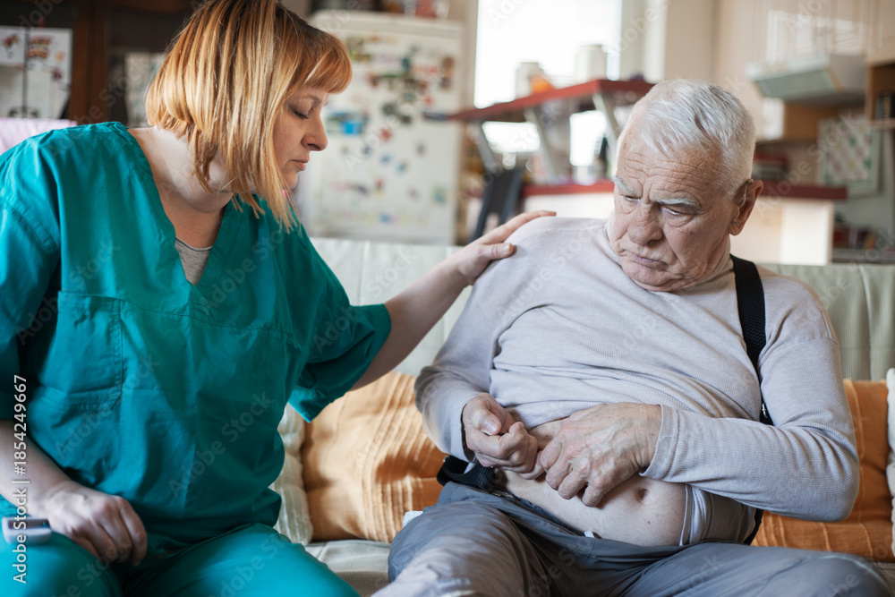 Obraz premium Home Healthcare Nurse Checking Blood Sugar of Elderly Man – Diabetes Care