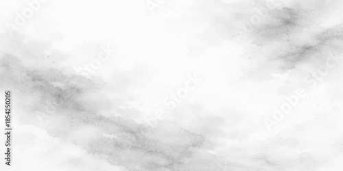 Fluffy white cumulus clouds drift across a beautiful bright blue summer sky in a clear sunny atmosphere