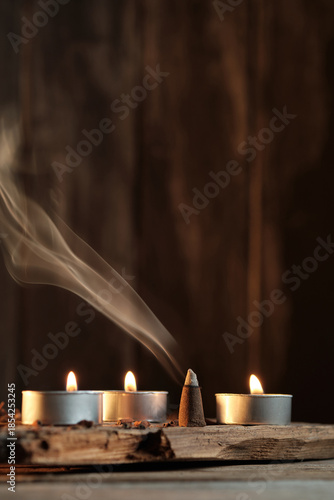 Candles and Incense Produce Smoke in a Simple Indoor Setting