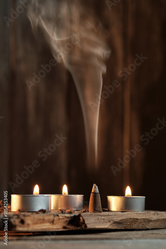 Candles and Incense Produce Smoke in a Simple Indoor Setting