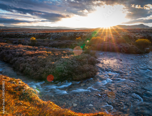 Golden sunset over tundra river in Rondane National Park