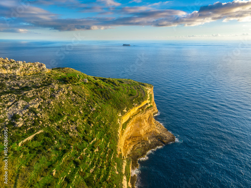 Drone view of cliffs and sea. Sunset, countryside, rocks. Filfla island and Dingli cliffs. Mediterranean sea, Malta