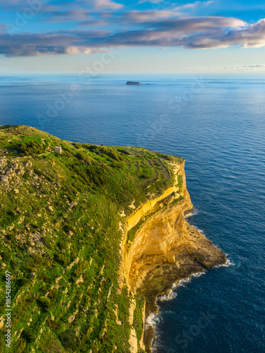 Drone view of cliffs and sea. Sunset, countryside, rocks, hills. Filfla island and Dingli cliffs. Mediterranean sea