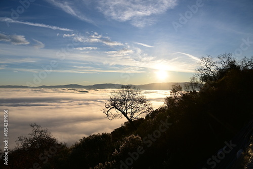 Stunning sunrise from a mountain top over the clouds