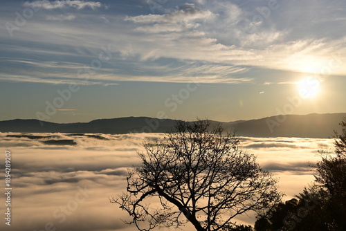 Stunning sunrise from a mountain top over the clouds