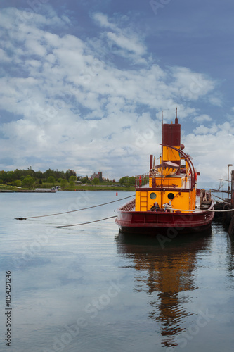 Tugboat Tied to Dock on Still Day