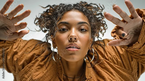 Young dancer performing modern choreography in slow motion on white background