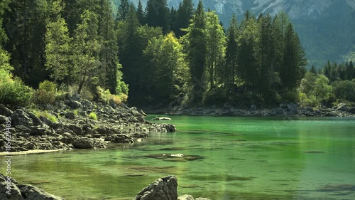 Explore a Lago di Cusine Surrounded by Trees and Mountains in Clear Daylight