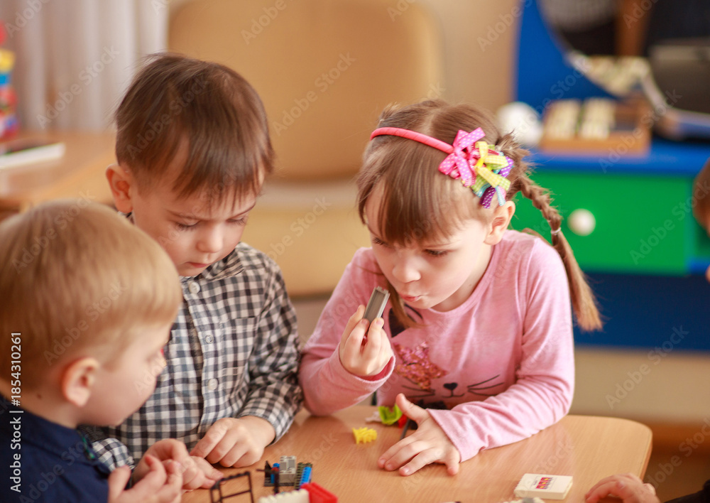 Naklejka premium Creative Children Play Together in a Vibrant Learning Environment, Exploring Toys and Expressing Curiosity During a Joyful Afternoon