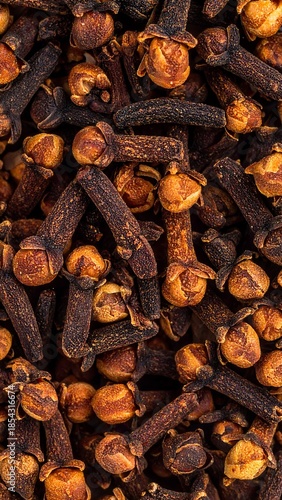 Wallpaper Mural Close-up overhead view of numerous dried whole cloves, showcasing their rich brown color and distinct shape, ready for culinary use as a spice. Torontodigital.ca