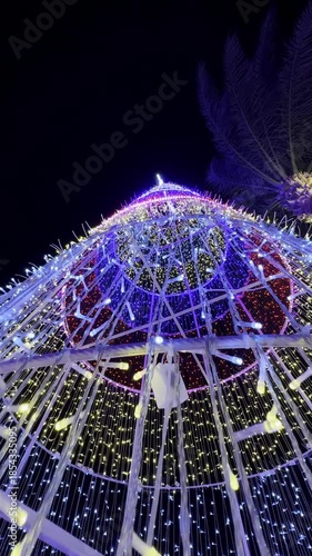 Illuminated Christmas tree structure at night