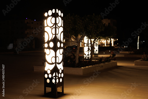 Photography Modern decorative light posts illuminate a night plaza