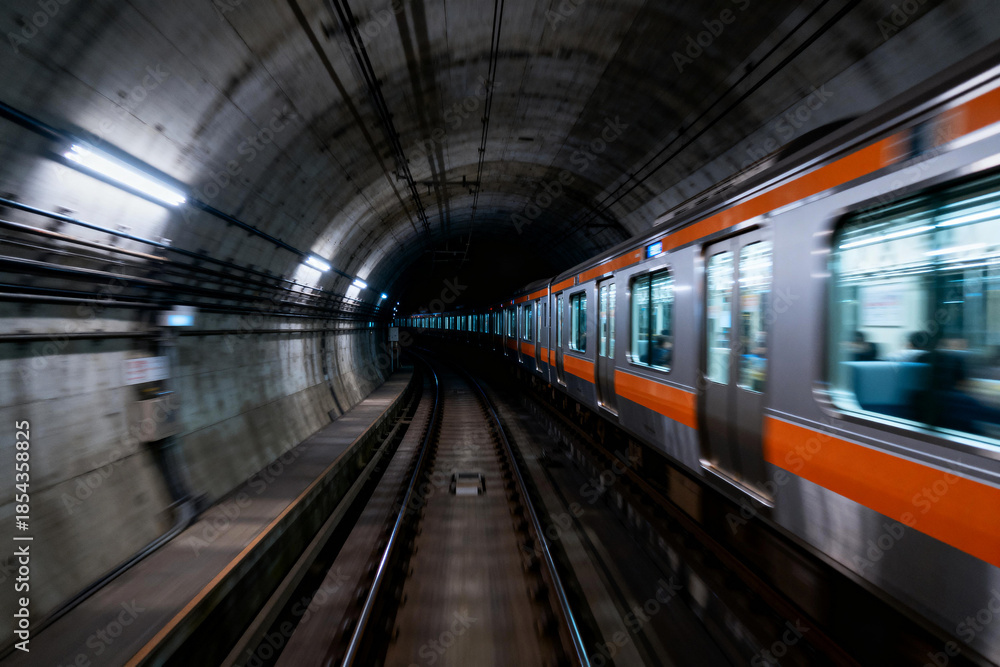 Obraz premium Subway Train in Motion Through Urban Tunnel