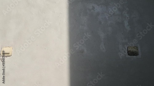 on off button of a light that is partially exposed to direct sunlight