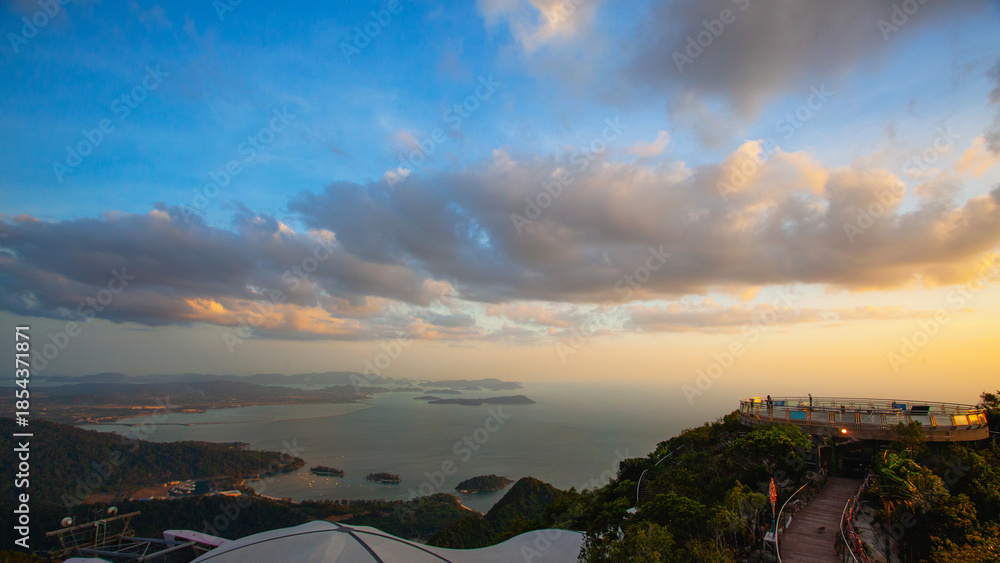 Αυτοκόλλητο Amazing view from Langkawi's cable car: Majestic Gunung Machincang unfolds below, a tapestry of lush greenery and dramatic cliffs against azure skies