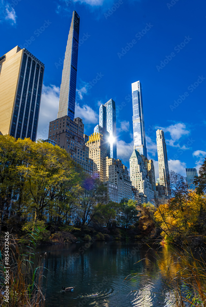 Fototapeta premium Central Park autumn lake with Manhattan skyscraper skyline in New York City
