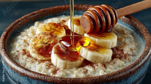 Delicious oatmeal topped with bananas and honey drizzle
