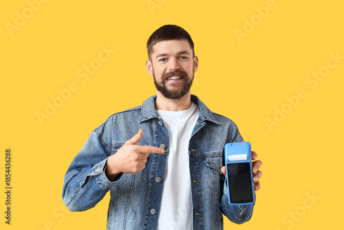 Young man pointing at payme...