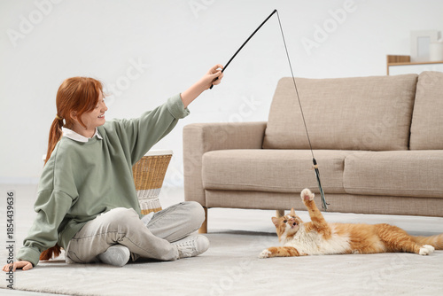 Redhead teenage girl playin...