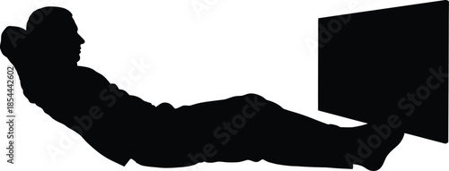 Silhouette of a man relaxing while watching a screen