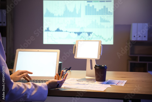 Wallpaper Mural Female data scientist working with laptop and documents at workplace in office, closeup Torontodigital.ca