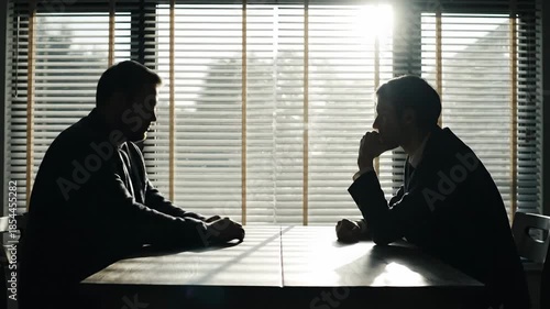 Two businessmen in a meeting room.