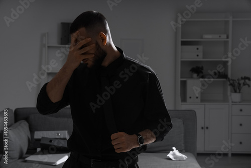 Depressed businessman in da...