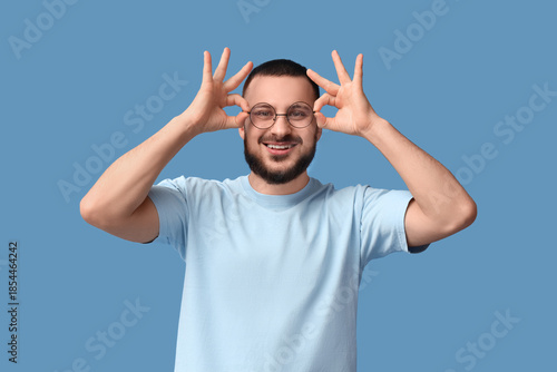 Young man in eyeglasses sho...