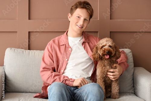 Young man with Toy Poodle d...