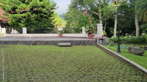 Scenic garden with lush greenery and serene outdoor space. Beautiful outdoor space with lush trees and manicured lawns. Peaceful garden area with green grass and charming landscape.