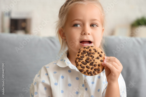 Cute little girl eating tas...