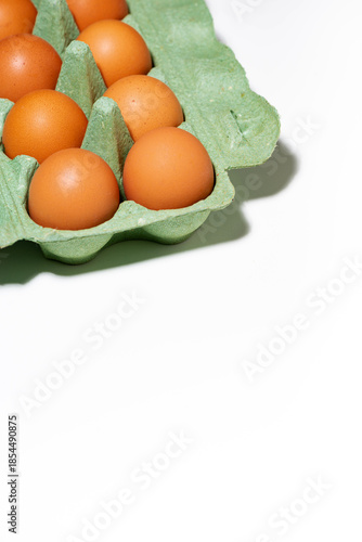 packaging with fresh whole chicken eggs on white background, vertical