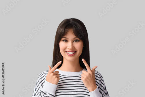 Young woman pointing at her...